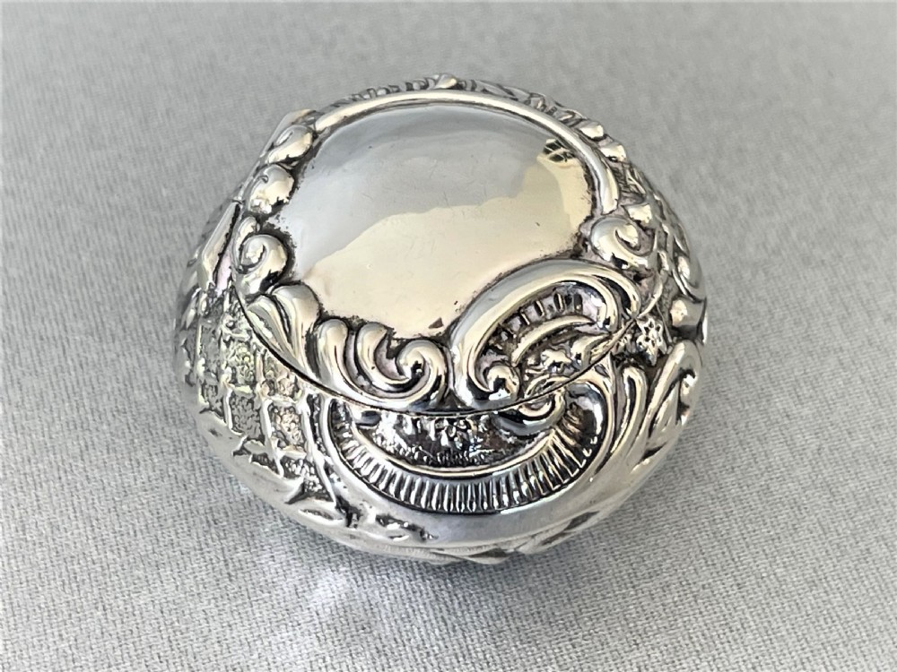 An unusual Edwardian silver repousse pill box