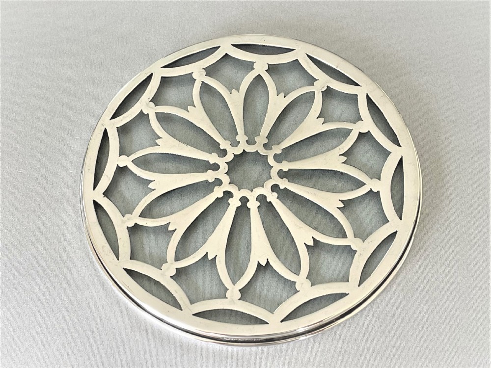 A delightful small silver teapotstand/coaster