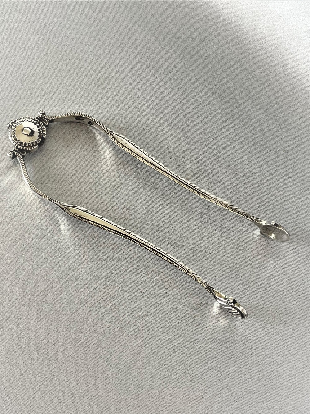 An extremely rare pair of 18th Century sprung silver tongs