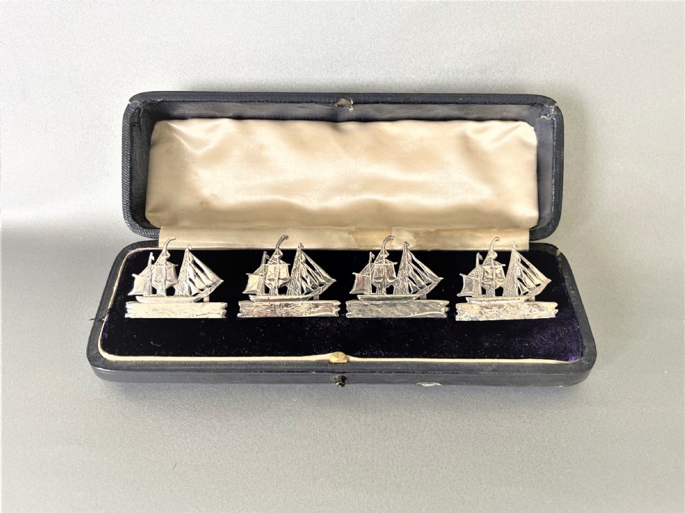 A fabulous set of 4 boxed Victorian silver ship menu card holders