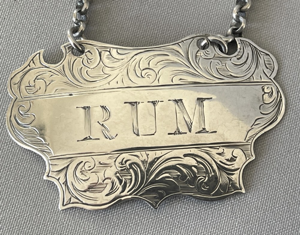A desirable pair of Victorian silver Rum & Gin decanter labels View II