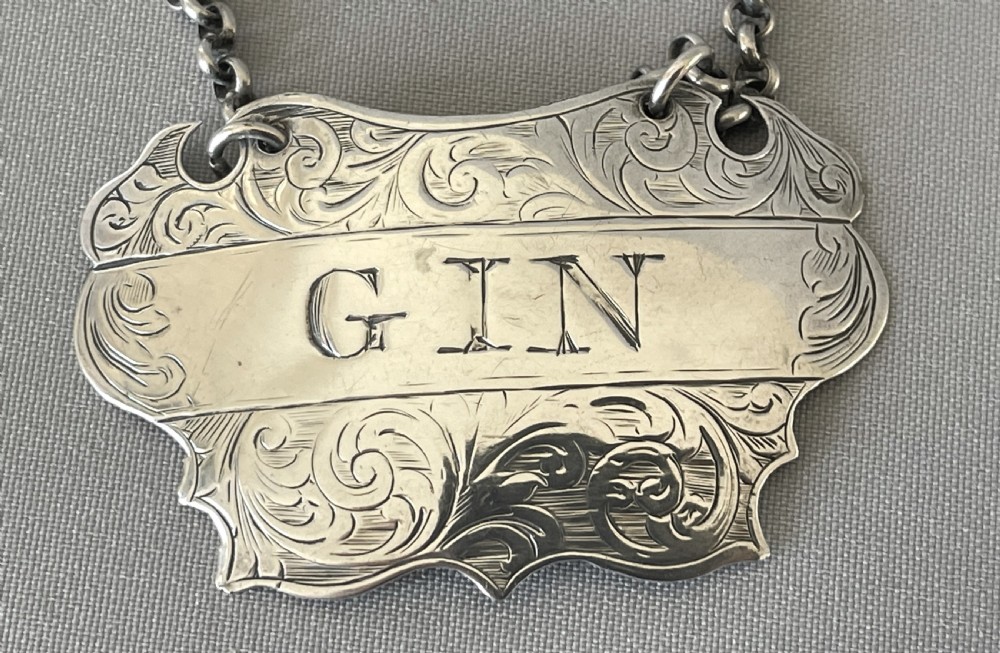 A desirable pair of Victorian silver Rum & Gin decanter labels View III
