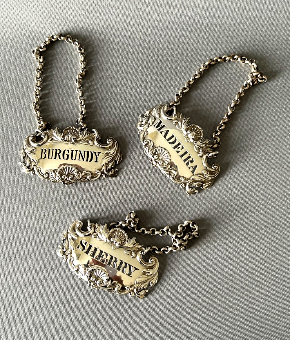 A superb set of 3 early Victorian silver decanter labels