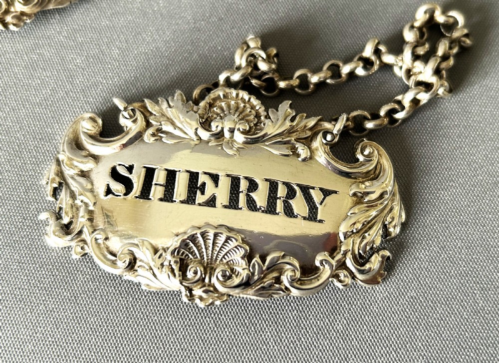 A superb set of 3 early Victorian silver decanter labels View II