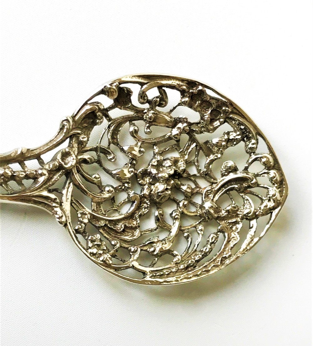 A lovely William Comyns Victorian cast silver bonbon spoon View II