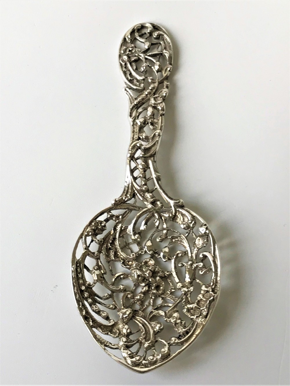 A lovely William Comyns Victorian cast silver bonbon spoon View IV