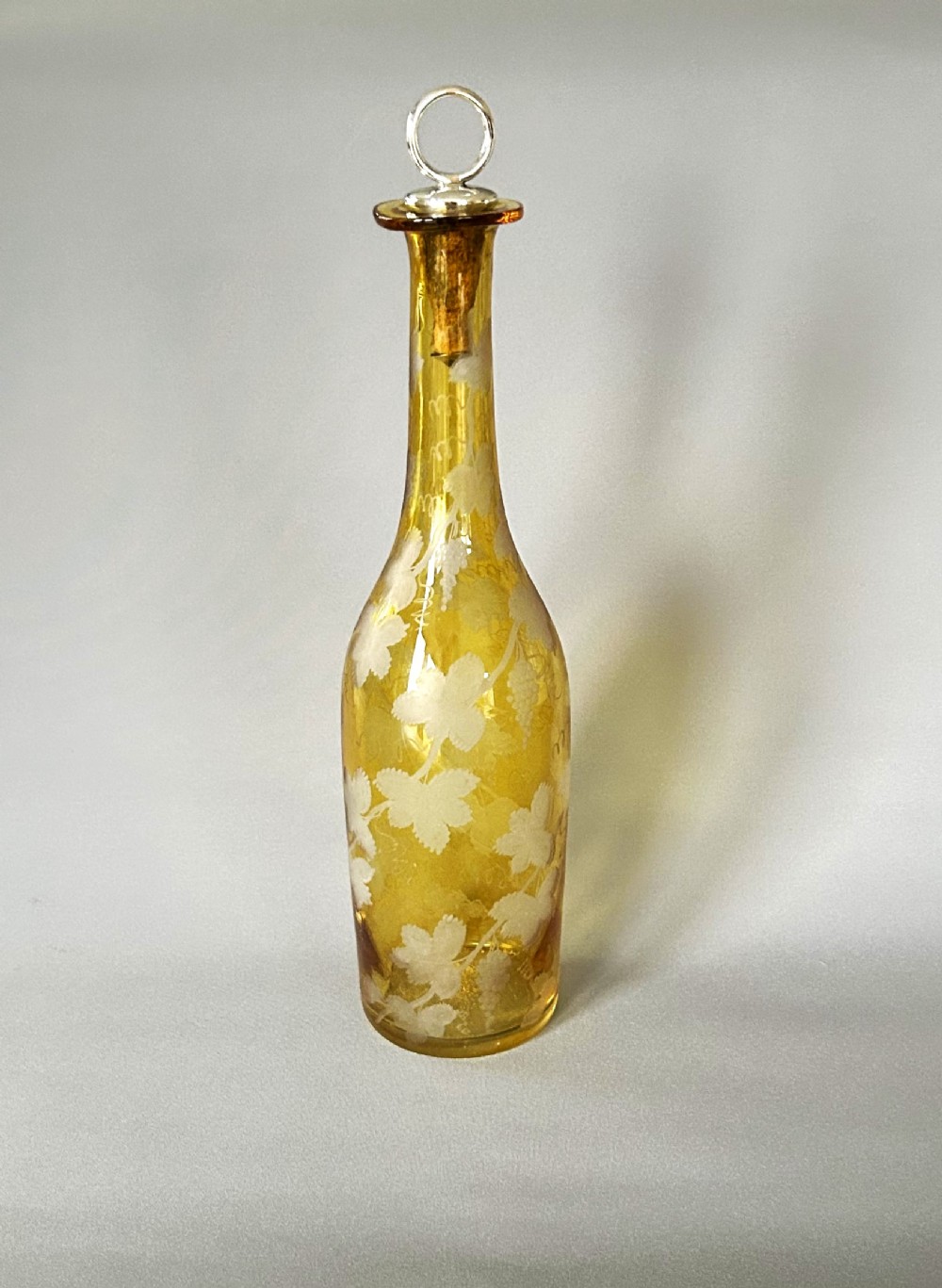 A rare early Victorian Amber glass & silver plate wine bottle