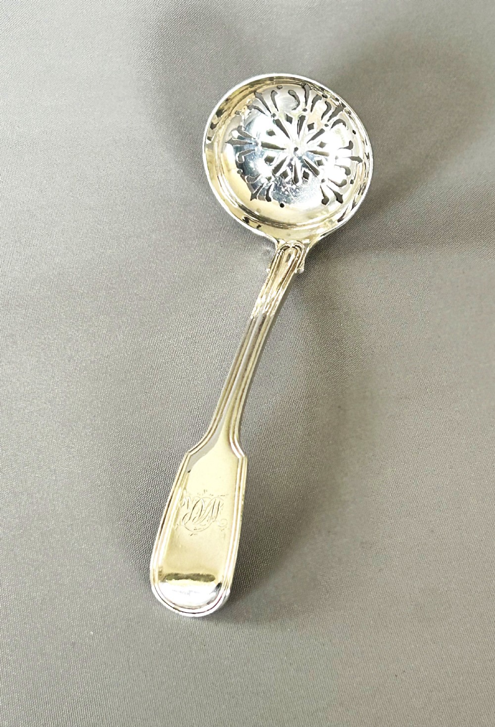 A Newcastle silver Fiddle & Thread sifter spoon