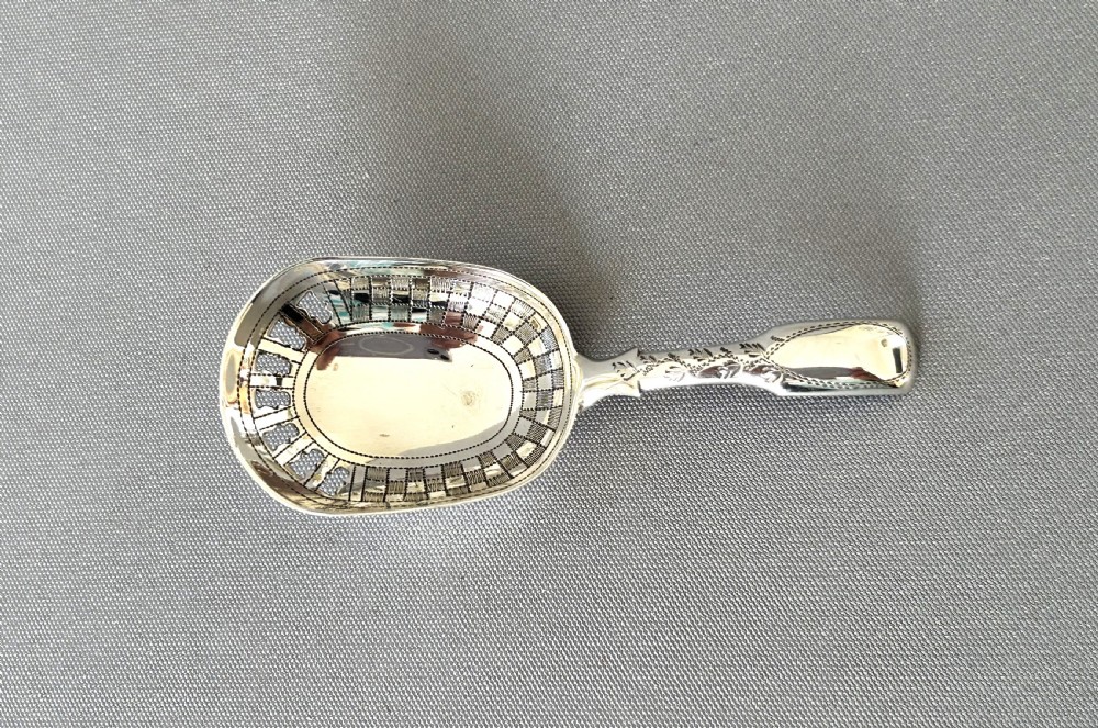 An unusual Georgian pierced bowl caddy spoon View II