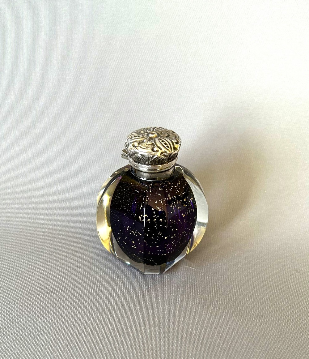 A fabulous Victorian silver mounted scent bottle with gold leaf