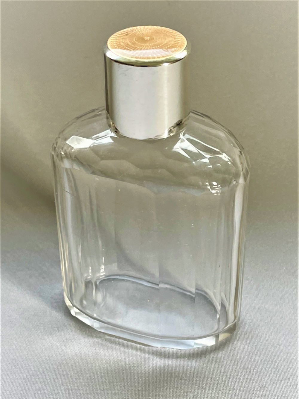 A gorgeous Art Deco silver & enamel topped cologne bottle