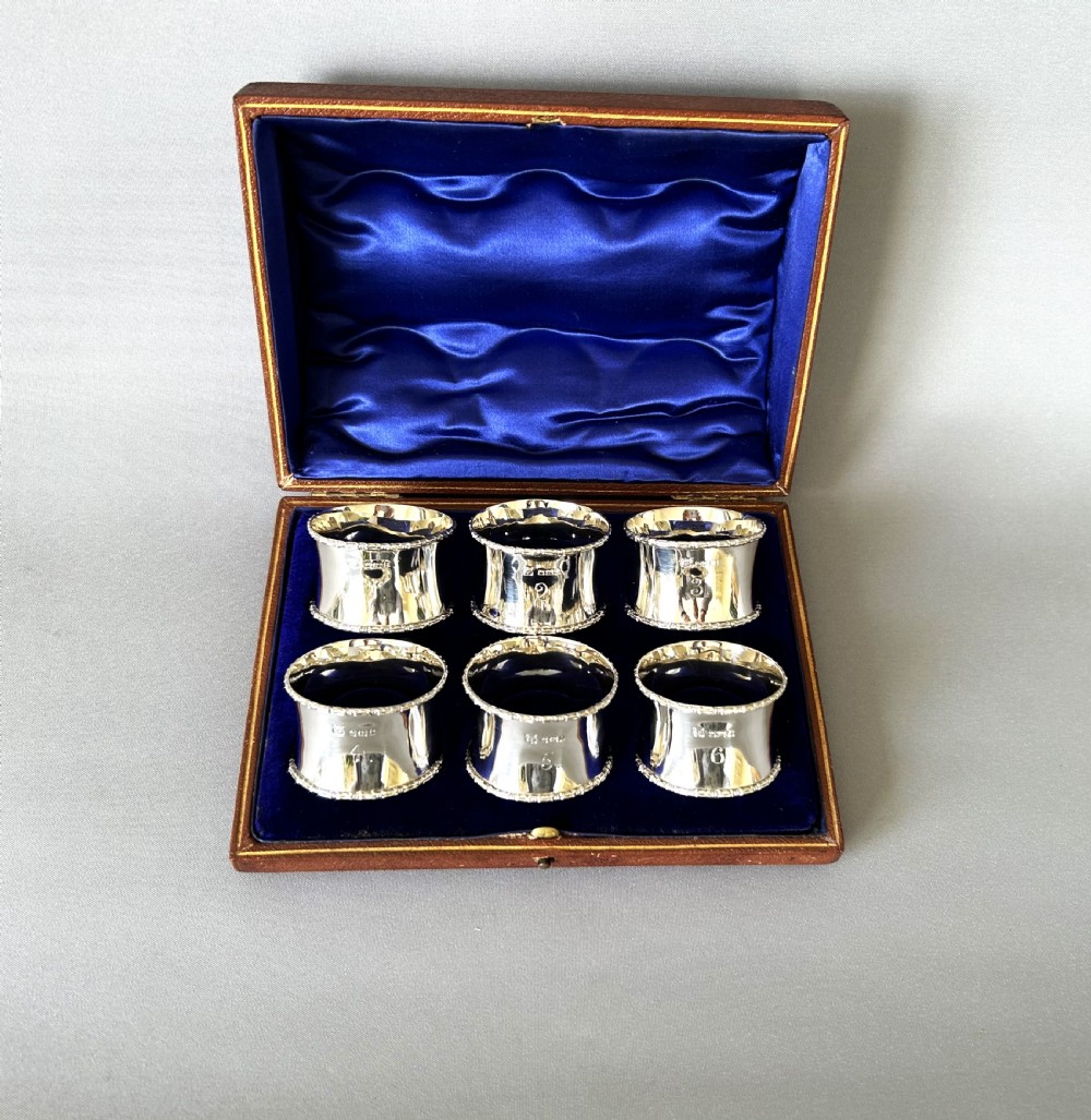 A handsome set of 6 boxed and numbered silver napkin rings View II