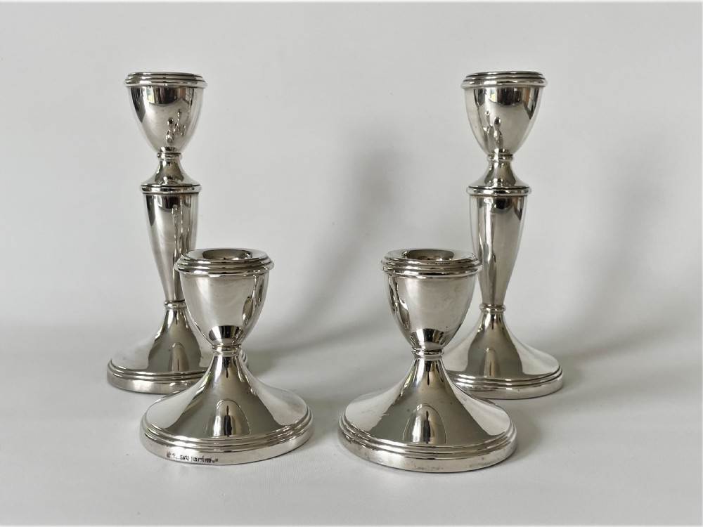 An unusual set of 4 hallmarked silver candlesticks View II