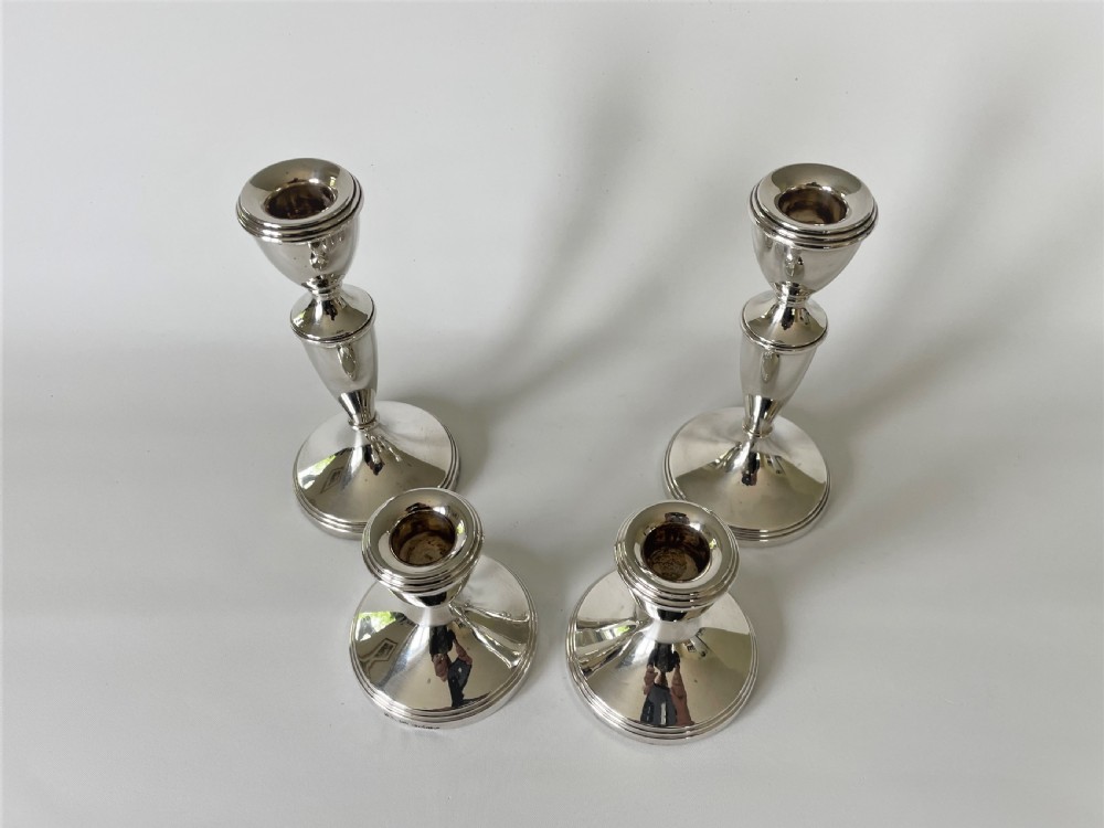 An unusual set of 4 hallmarked silver candlesticks View III