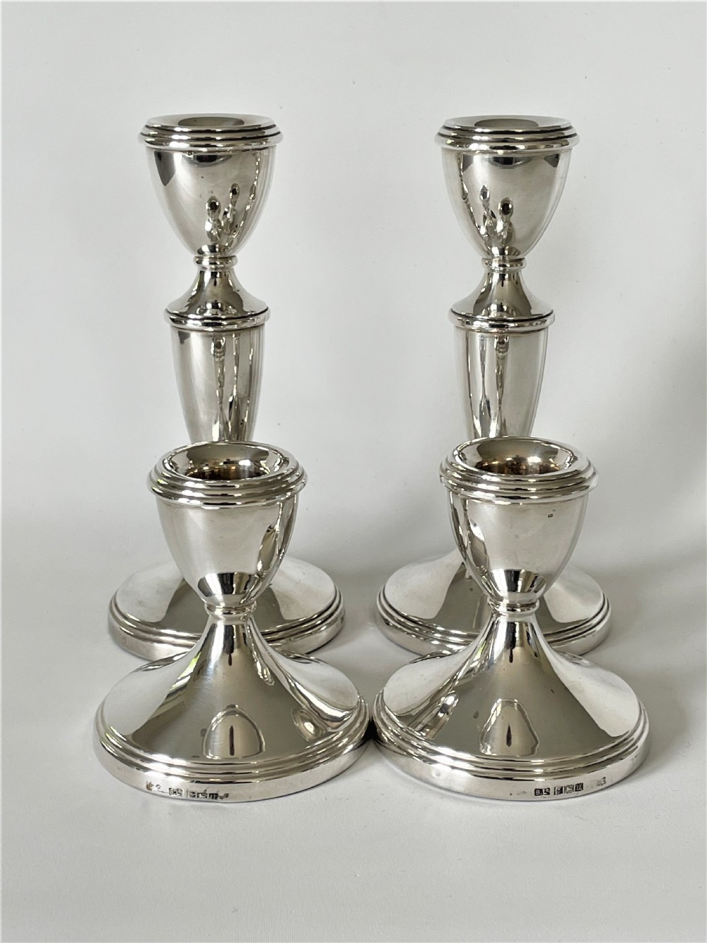 An unusual set of 4 hallmarked silver candlesticks View V