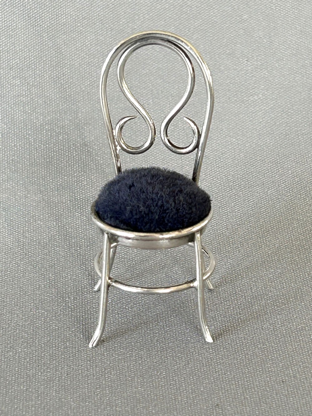 An unusual Victorian silver salon chair pin cushion
