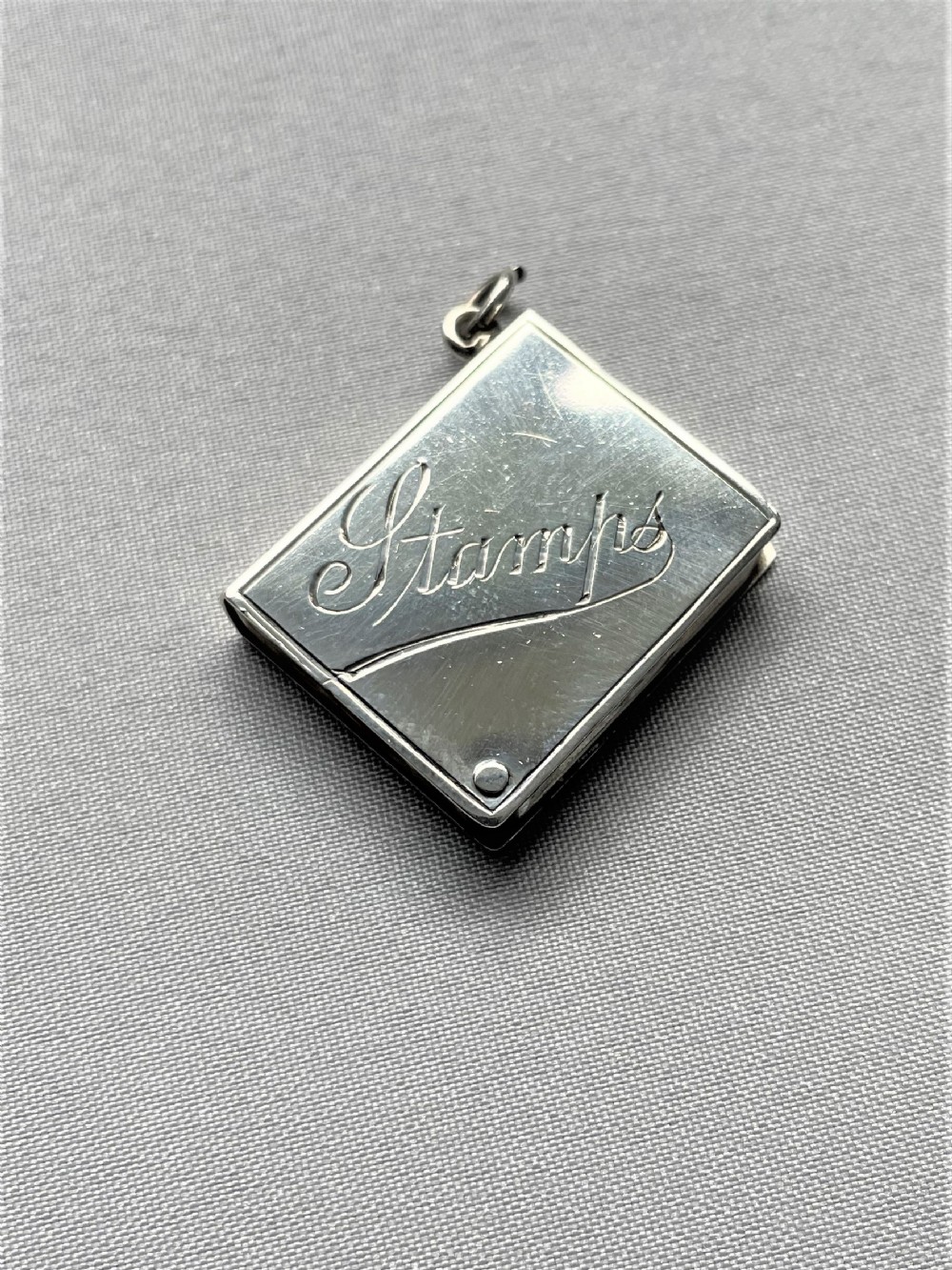 A novelty silver 'book' stamp case