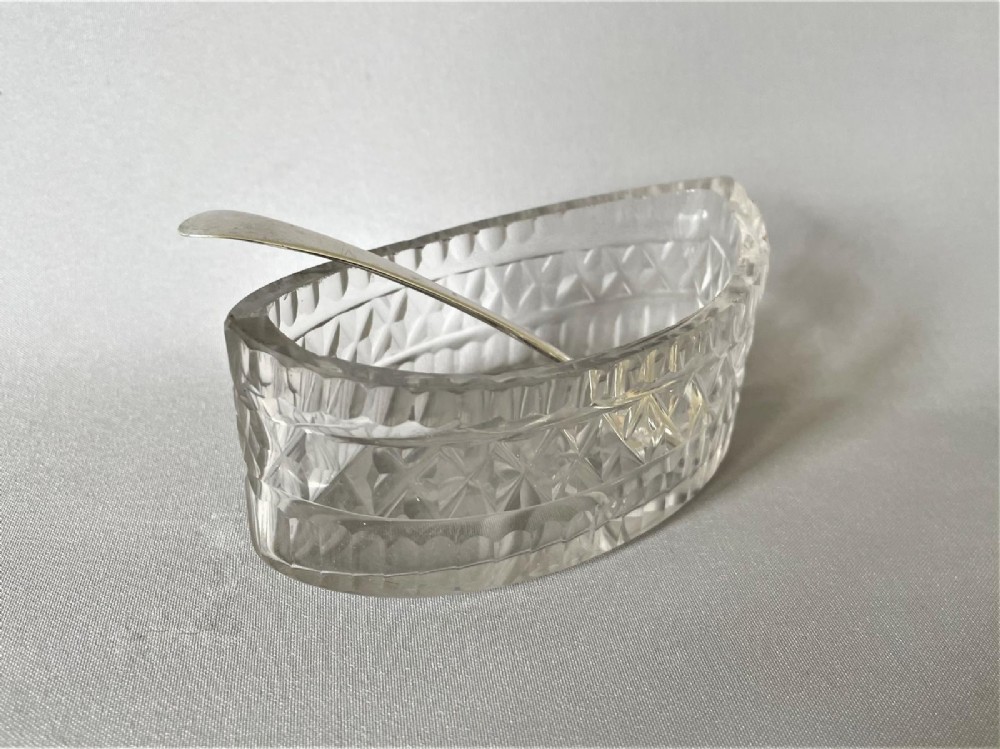 A Georgian cut glass condiment boat & silver spoon.