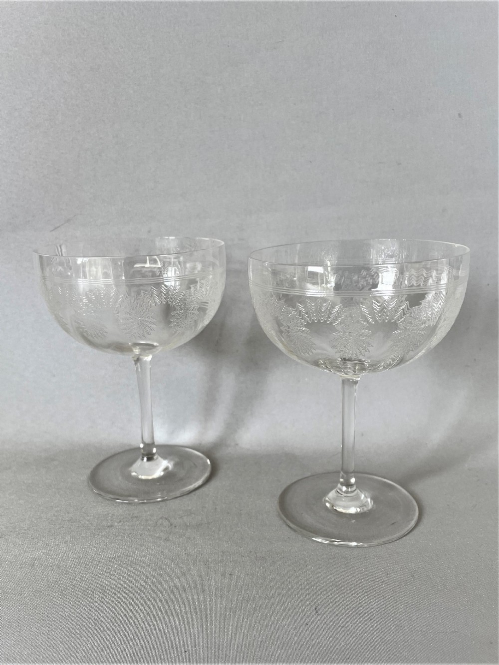 A delightful pair of Edwardian etched champagne bowls