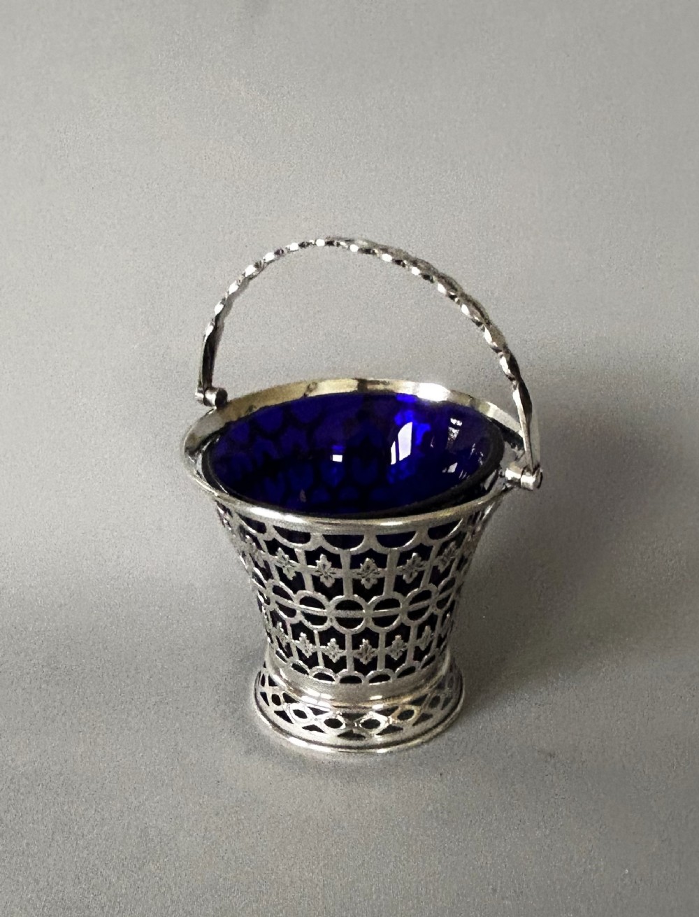 A late Victorian silver swing handled basket