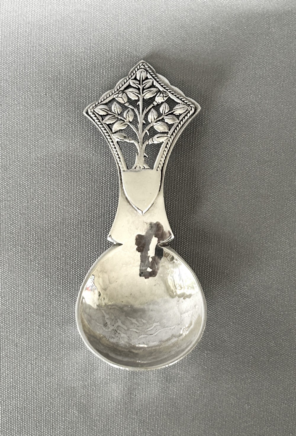 A Rare Arts & Crafts 'Tree of life' silver caddy spoon