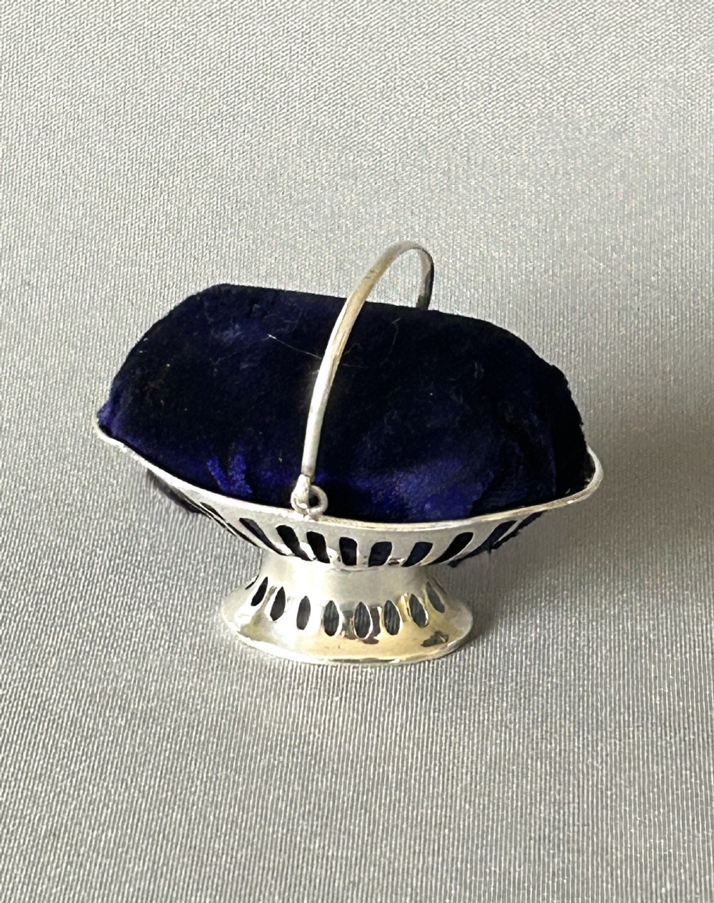 A Novelty silver fruit basket pin cushion