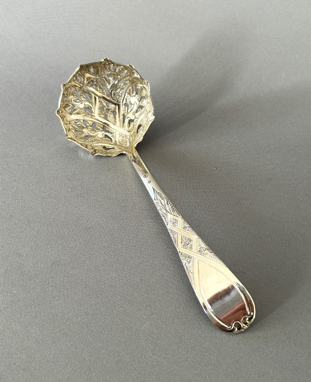 A fabulous Georgian silver sugar sifter spoon