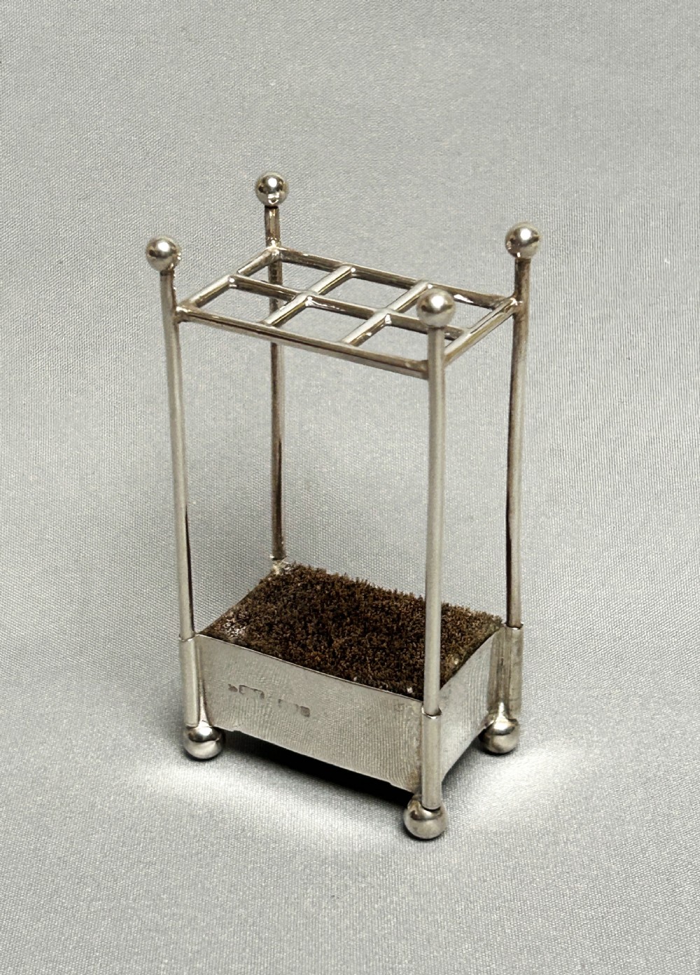 A rare novelty Edwardian silver 'stick stand' pen wipe