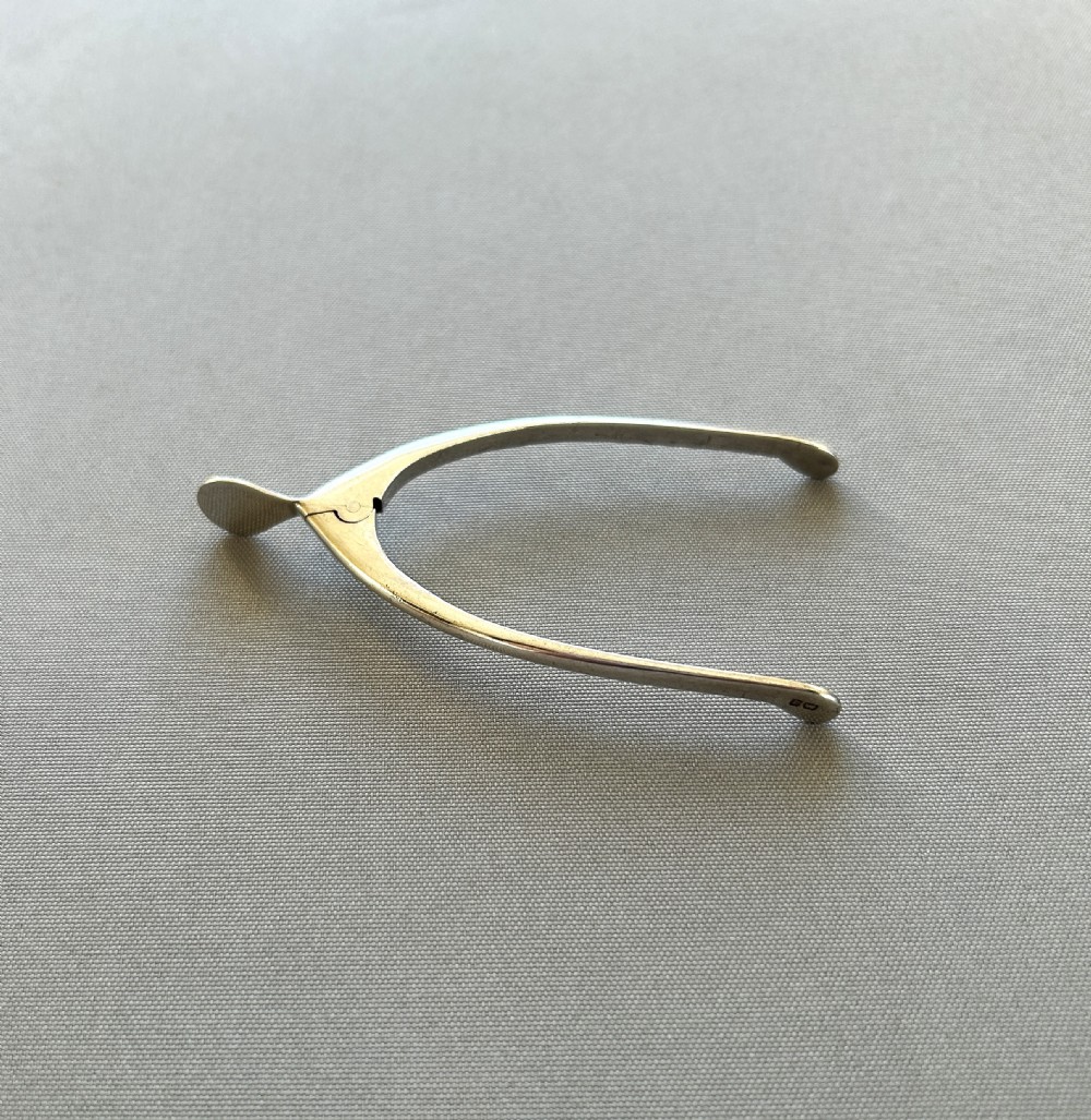 A pair of novelty silver wishbone sugar tongs View II