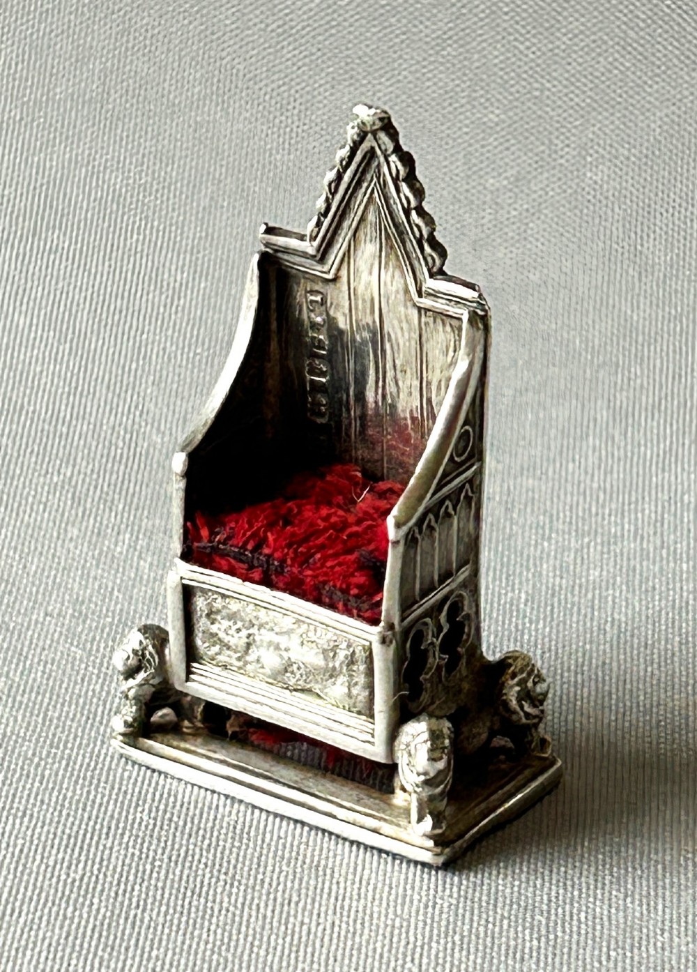 An Edwardian coronation chair silver pincushion