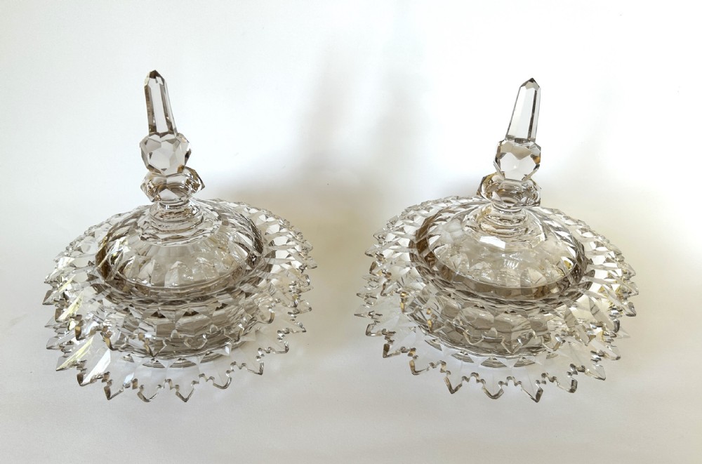 A fabulous pair of Victorian cut glass lidded butter dishes with saucers
