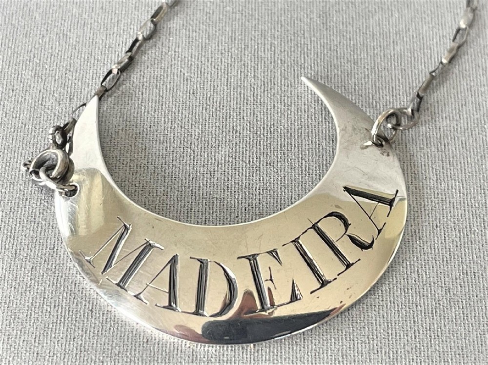 A late 18th Century silver crescent madeira label
