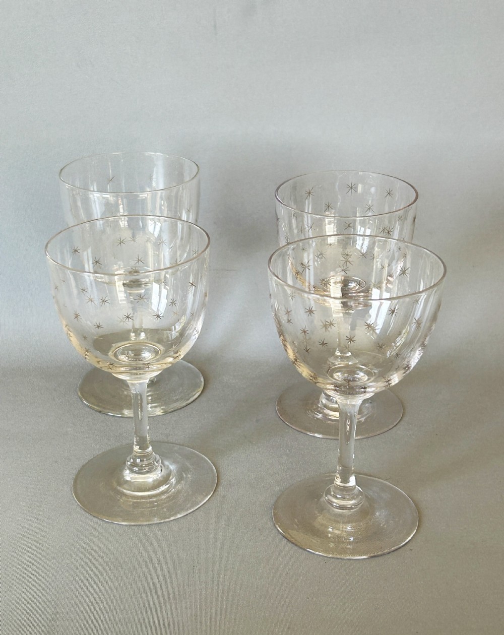 A charming set of 4 Victorian star etched dessert wine glasses