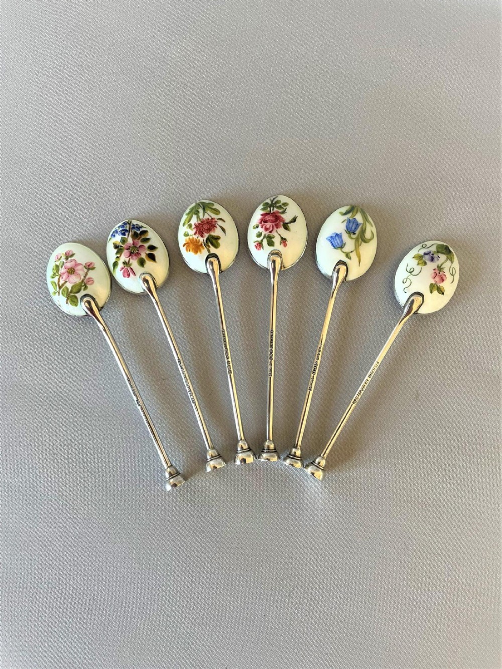 An exquisite set of 6 handspainted silver & enamel coffee spoons