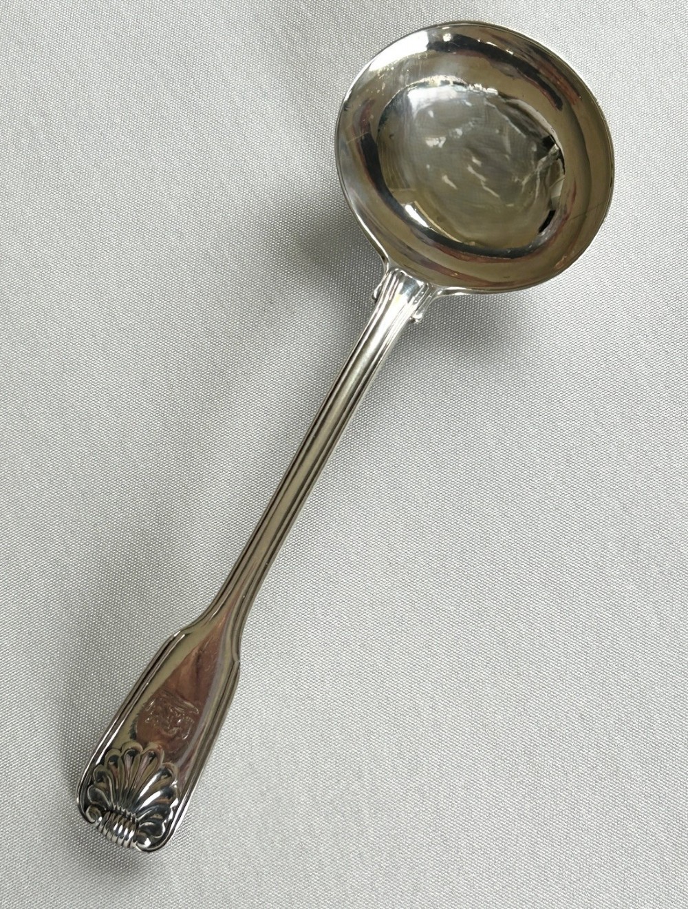 A Paul Storr Fiddle, Thread & Shell silver gravy ladle
