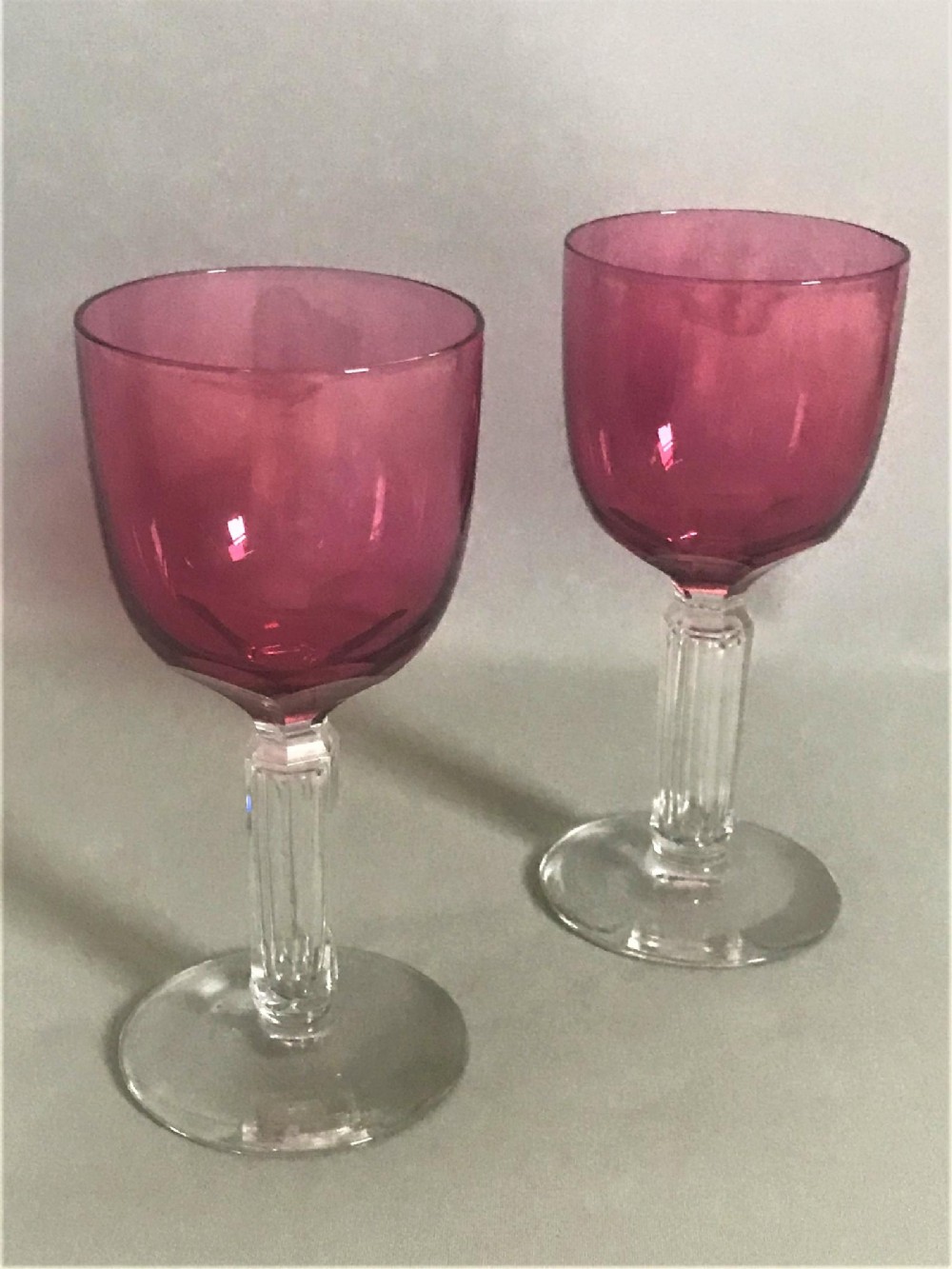 A gorgeous pair of Victorian cranberry bowl wine glasses
