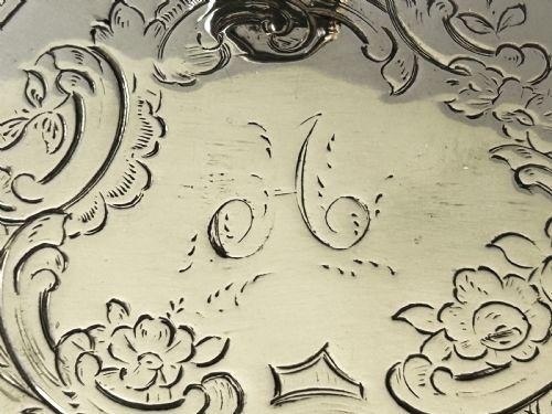 An early Victorian silver mustard pot with pierced fretwork sides, a cobalt blue glass liner, an engraved flat hinged lid, and a scroll handle. View IX