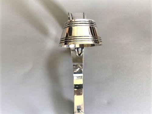 An Edwardian silver-plated champagne bottle holder featuring an adjustable collar mechanism and a curved pouring handle. View II