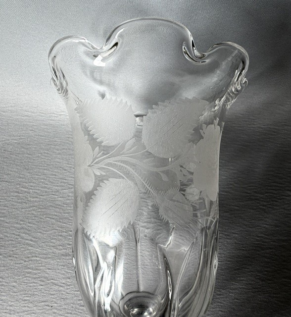 A clear glass Victorian celery vase featuring an etched floral pattern, a scalloped frilled rim, and a stemmed circular foot. View VII