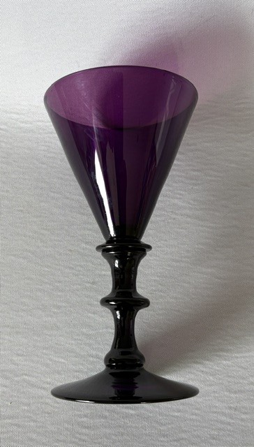 A Georgian purple amethyst glass wine flute featuring a conical bowl, double-knopped stem, and circular foot. View V