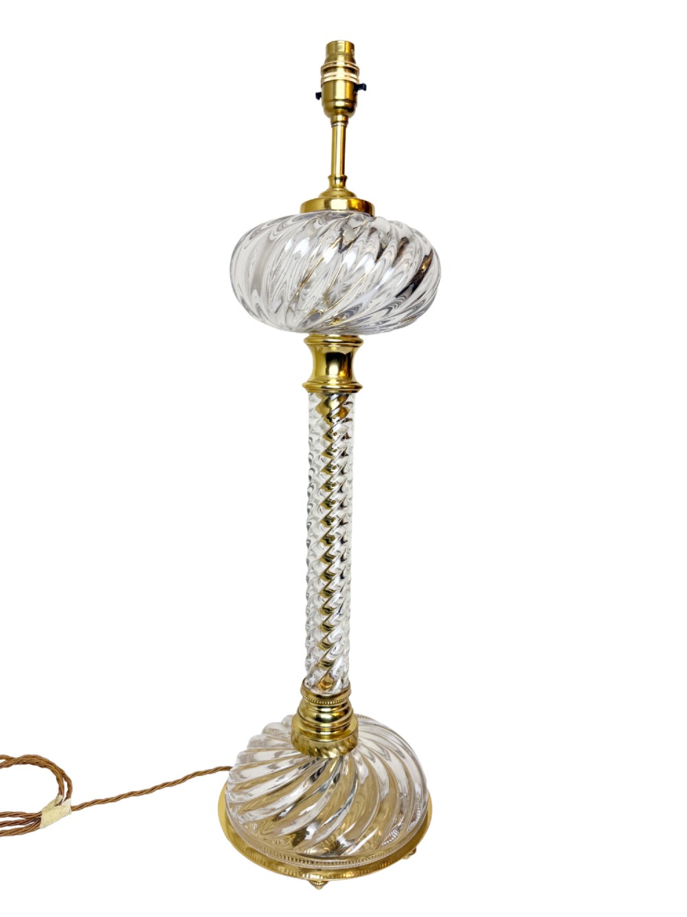 A 19th-century French table lamp featuring a twisted clear crystal column and swirled glass base accented with gilt bronze fittings.