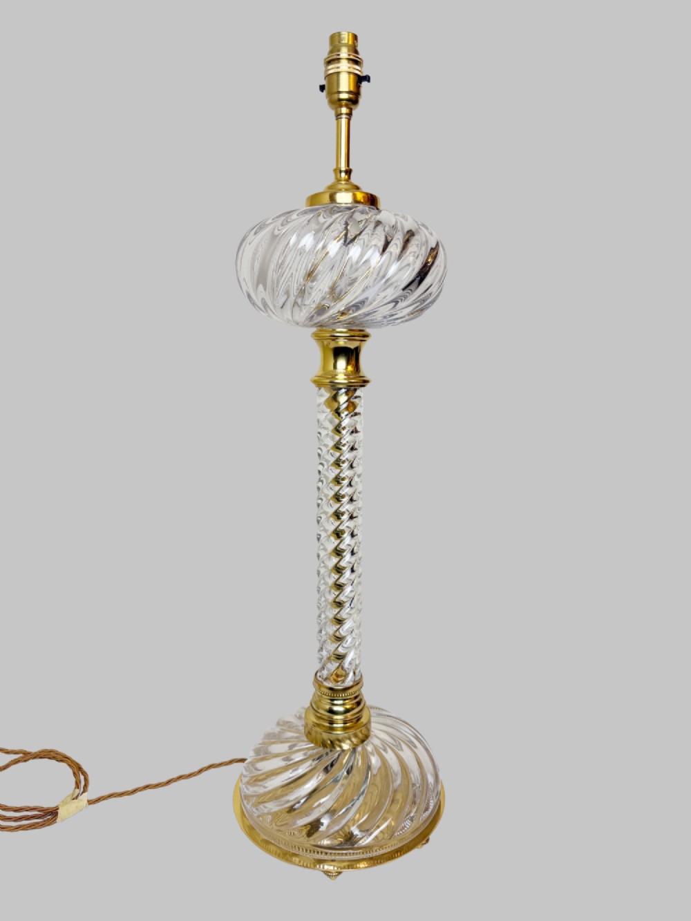 A 19th-century French table lamp featuring a twisted clear crystal column and swirled glass base accented with gilt bronze fittings. View II