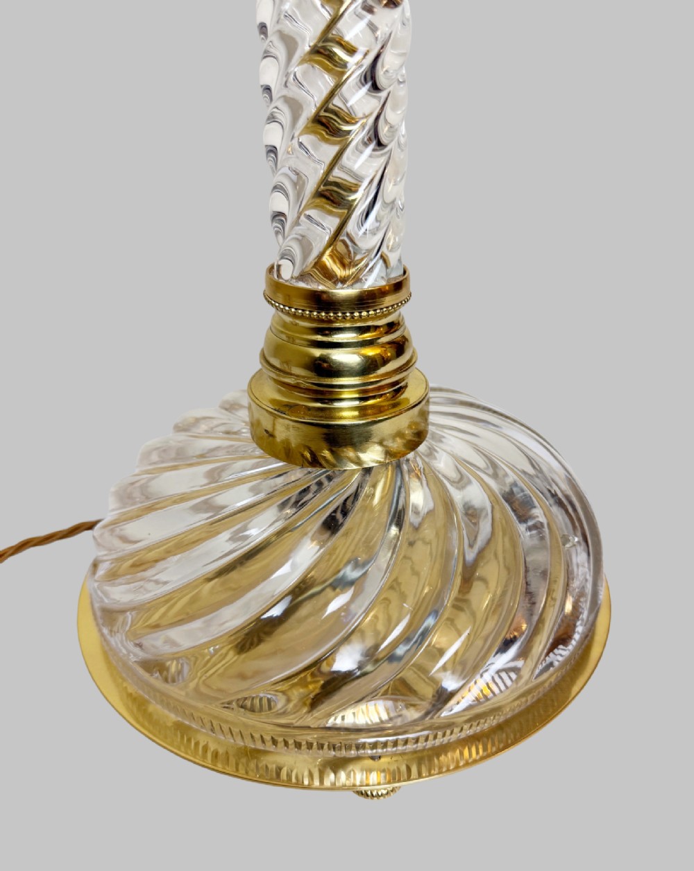 A 19th-century French table lamp featuring a twisted clear crystal column and swirled glass base accented with gilt bronze fittings. View V