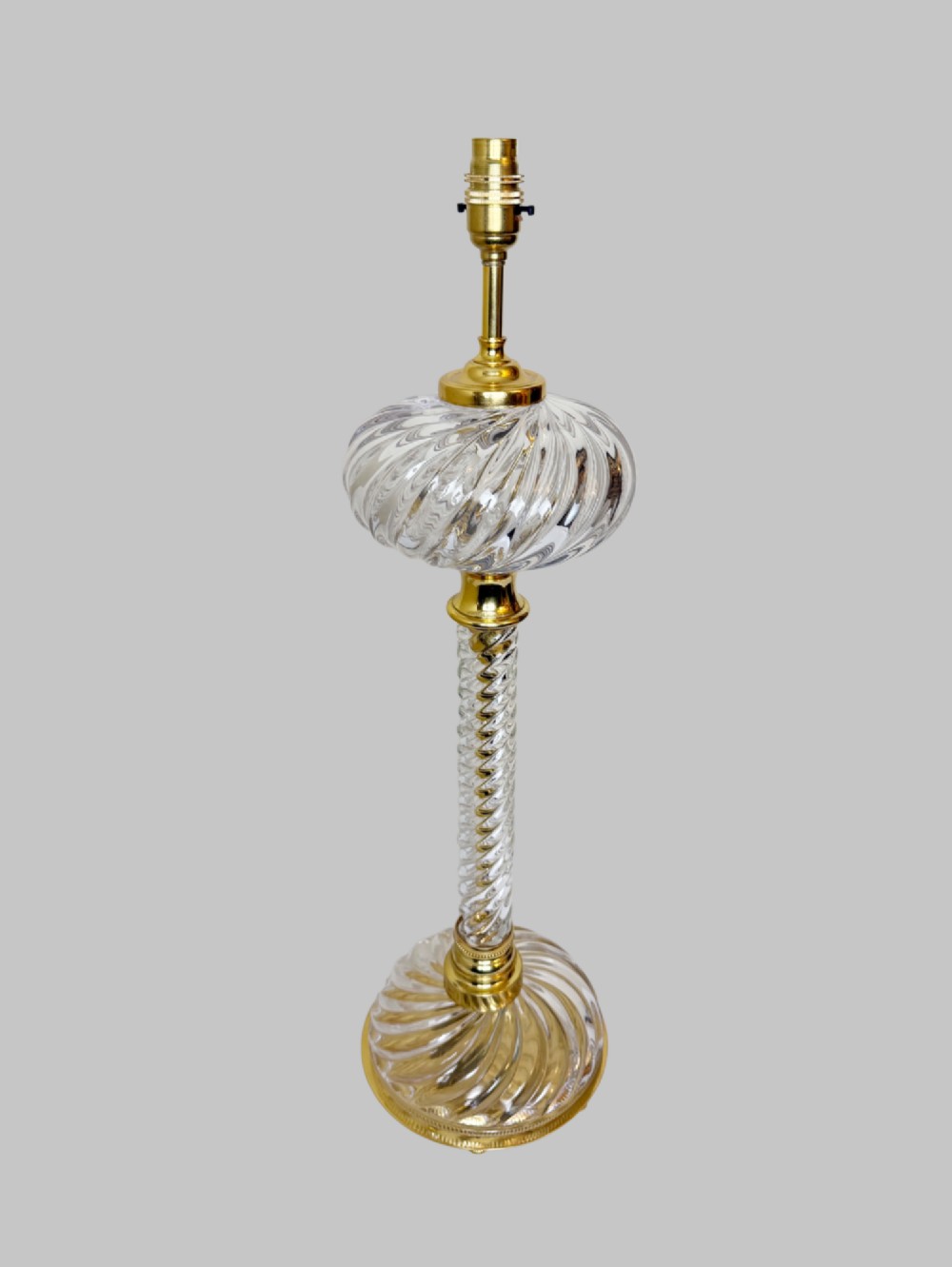 A 19th-century French table lamp featuring a twisted clear crystal column and swirled glass base accented with gilt bronze fittings. View VII