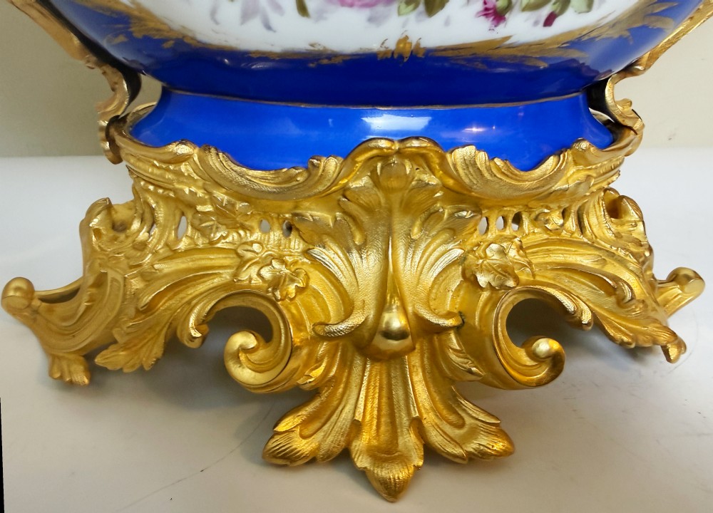A mid-19th-century cobalt blue porcelain centrepiece bowl featuring a hand-painted pastoral scene, gilded foliage patterns, and cast gilt bronze scroll handles and base. View VII
