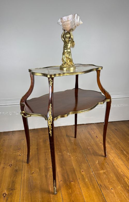 fig 1. A French Napoleon III style two-tier tea table featuring an onyx inset top shelf, a mahogany lower shelf with side handles, cabriole legs, and gilded bronze mounts.
