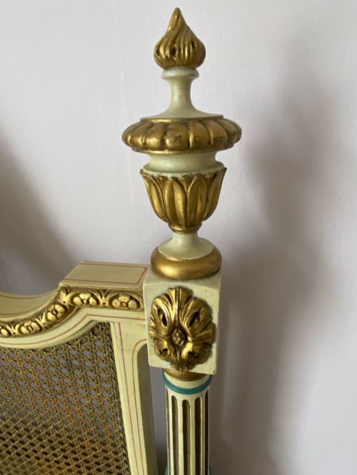 fig 1. A pair of antique cream and gilt painted single beds featuring caned headboards with central painted portrait medallions and carved paw feet.