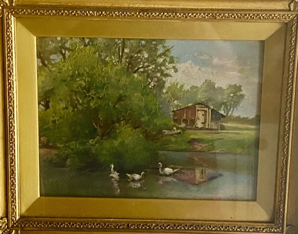 An impressionist oil painting on board depicting a serene rural pond with ducks, surrounding green trees, and a wooden barn, presented in an ornate gilt frame. View III