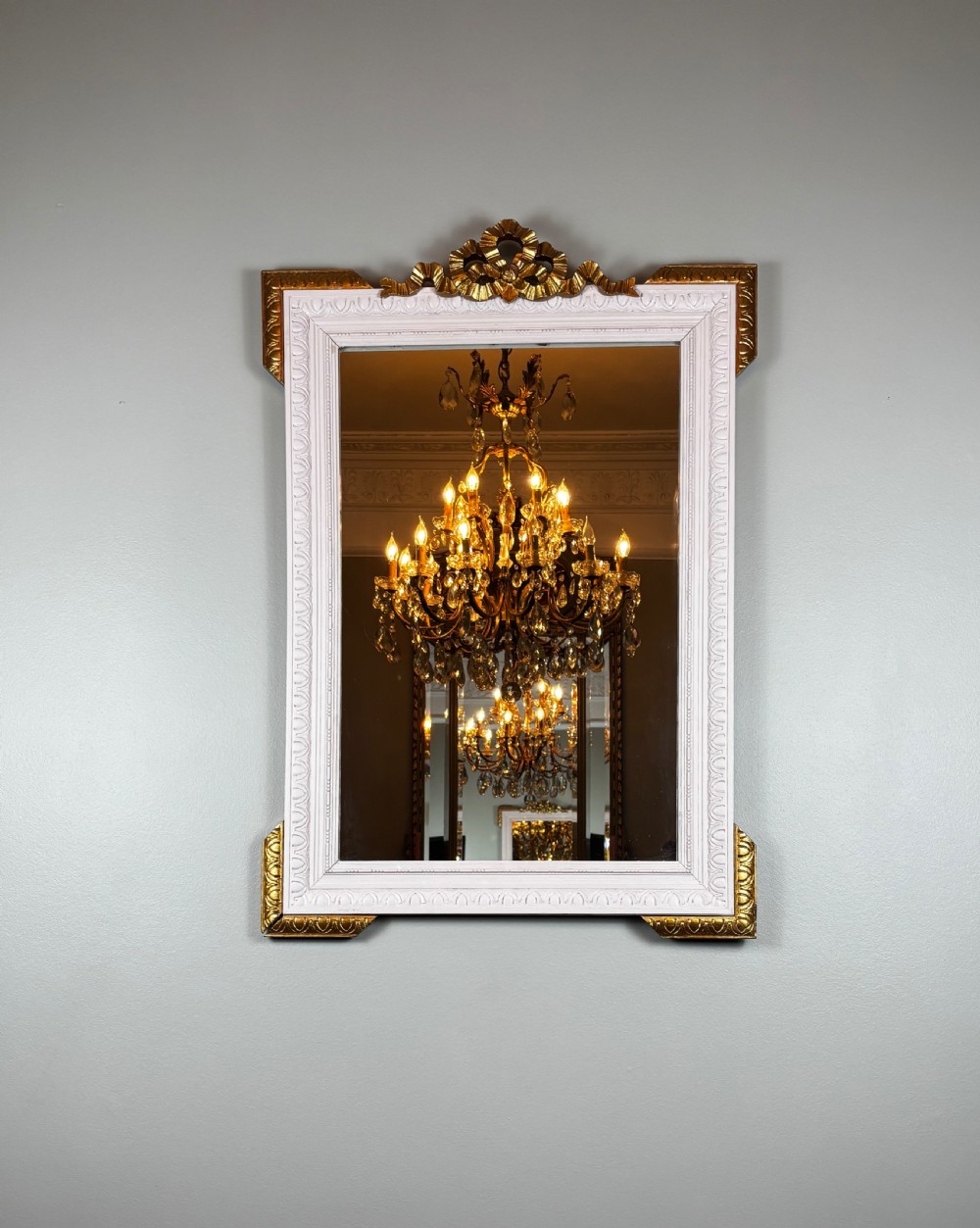Rectangular late nineteenth-century French mirror featuring a painted white frame with gilded cresting and decorative corner accents. View II