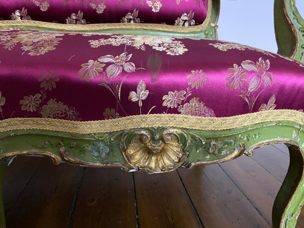 An early 19th-century Italian Venetian sofa featuring a carved green and gold polychrome frame with cabriole legs, upholstered in a rich magenta floral damask fabric. View III